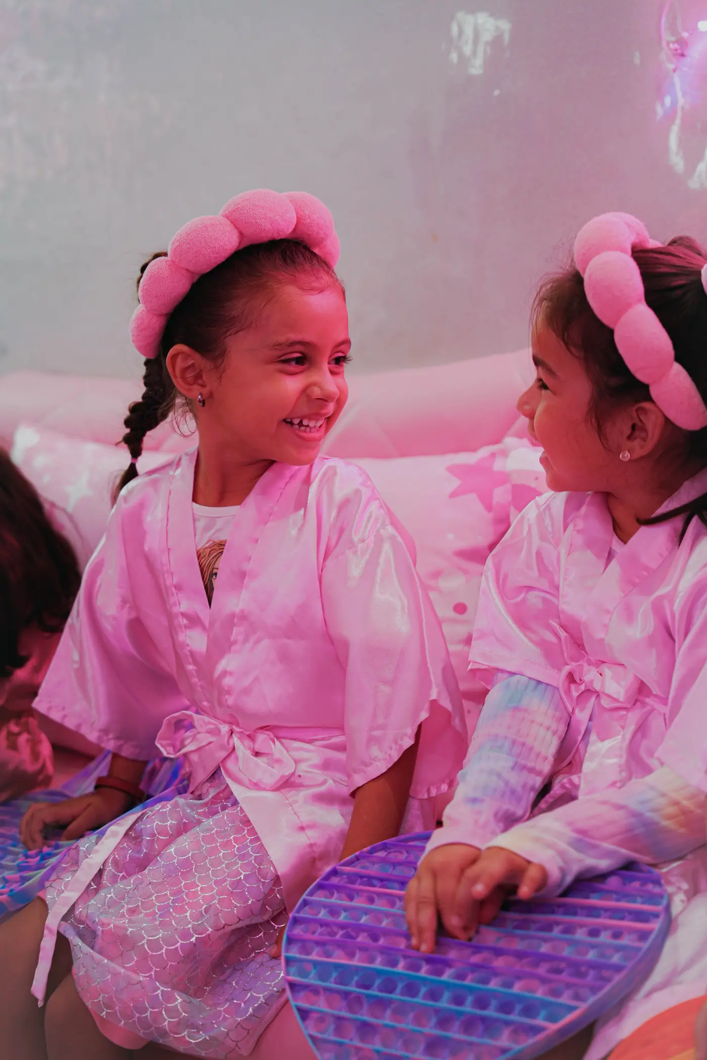 Girls in pink spa robes enjoying the party